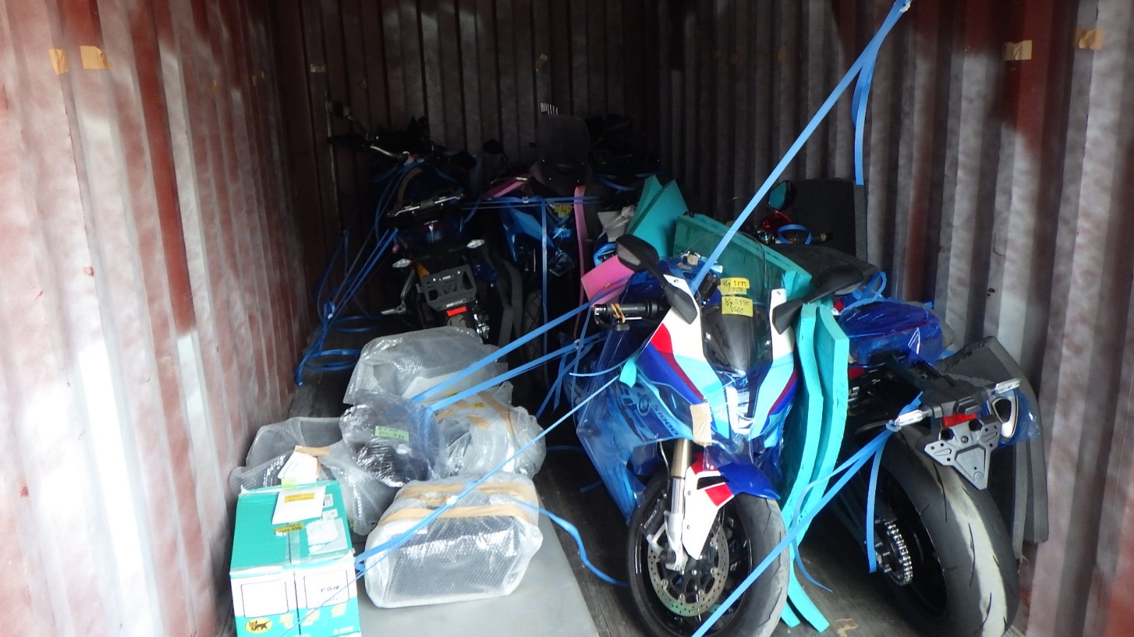 Motorcycles loaded and lashed inside an export container